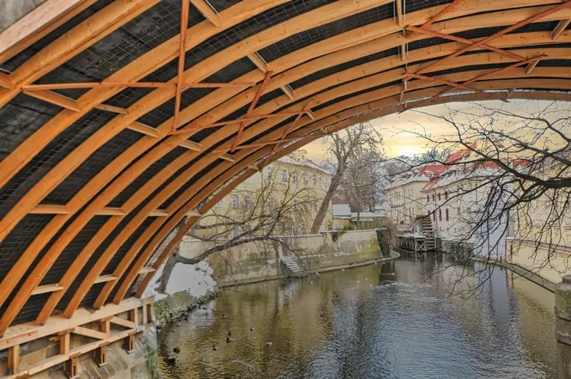 1.Certovka canal beside Kampa Island in Prague seen under a wooden arch