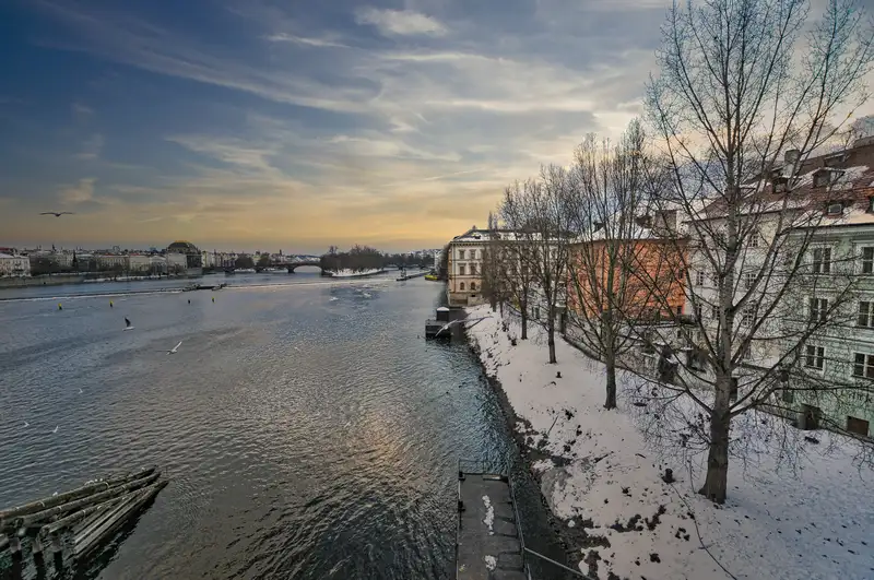 Snow-lined riverbank along the Vltava in Prague (winter light)