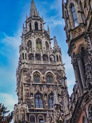The Gothic spire of Munich's New Town Hall on Marienplatz against a blue sky in Germany