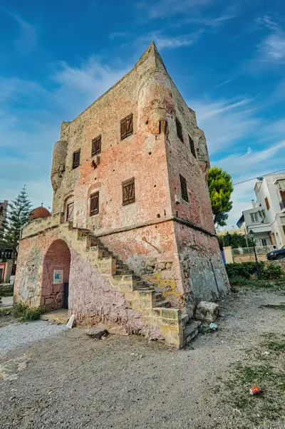 The pink stone Markellos Tower in Aegina Town, a 17th century historical building with an arched entrance and stone staircase where Greece's first government convened