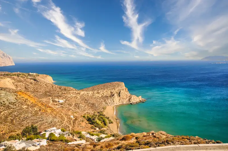 Aerial view of Kleisidi beach in Anafi with turquoise waters and golden coastline