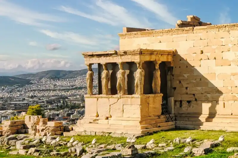 Ancient Caryatid statues on the Acropolis of Athens overlooking the city