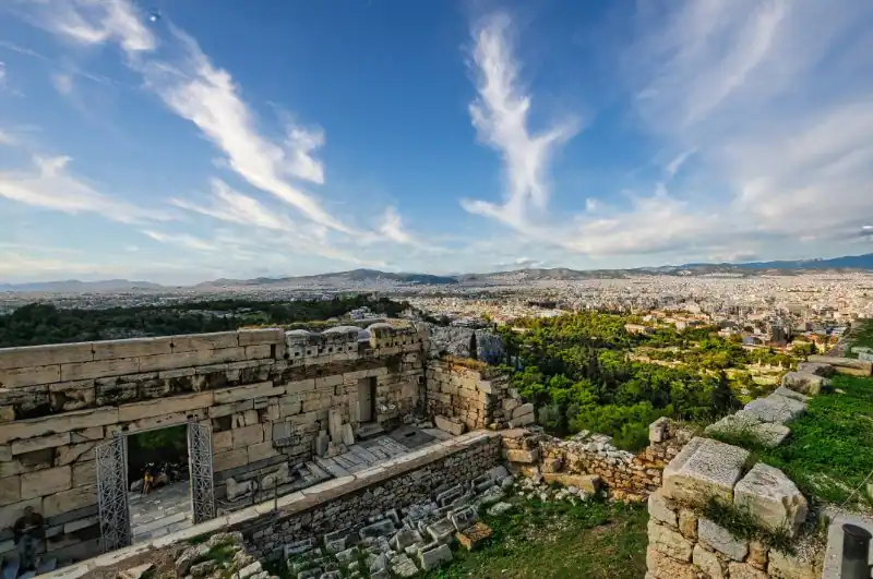 View of Athens city from inside the Acropolis walls with ancient stone blocks in the foreground