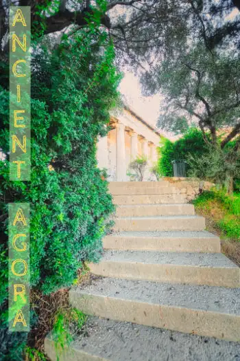Stone steps leading to the Temple of Hephaestus in the Ancient Agora of Athens surrounded by greenery