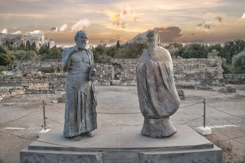 Statues of Socrates and Confucius in the Ancient Agora of Athens with the Acropolis in the background