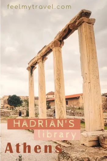 Tall Corinthian columns of Hadrian's Library in Athens standing against an overcast sky