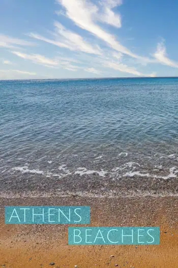 Clear turquoise water meeting golden sand at a beach near Athens, Greece