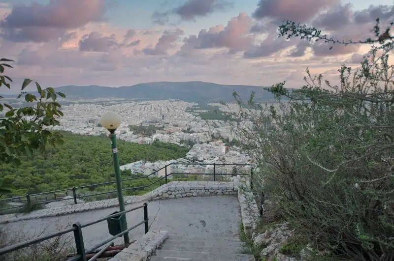  Stone steps leading down from Lycabettus Hill with a panoramic view of Athens and the surrounding mountains