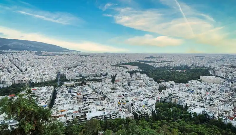 Panoramic view of Athens from the top of Lycabettus Hill showing the city stretching to the mountains and the sea