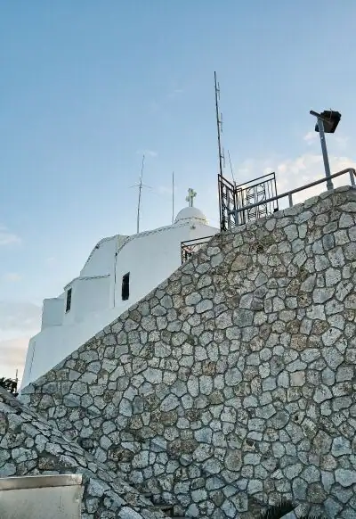 Stone steps and wall leading up to the whitewashed Saint George church at the top of Lycabettus Hill in Athens