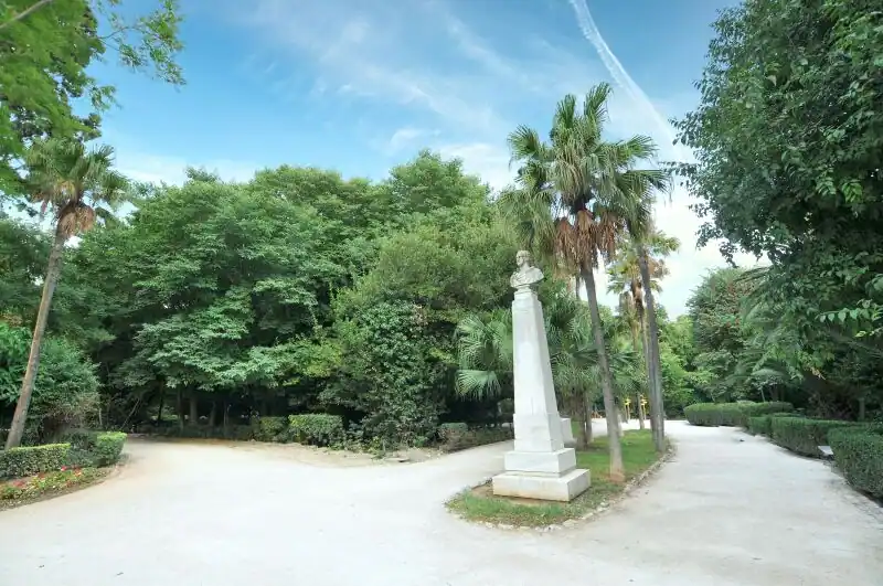 One of the historical busts displayed on a stone pedestal inside the National Garden Athens Greece