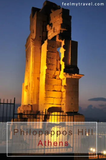 The Philopappos Monument in Athens illuminated at night against a deep blue sky