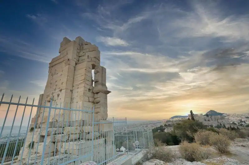 Philopappos Monument on top of Philopappos Hill in Athens with a panoramic view of Lycabettus Hill and the city skyline