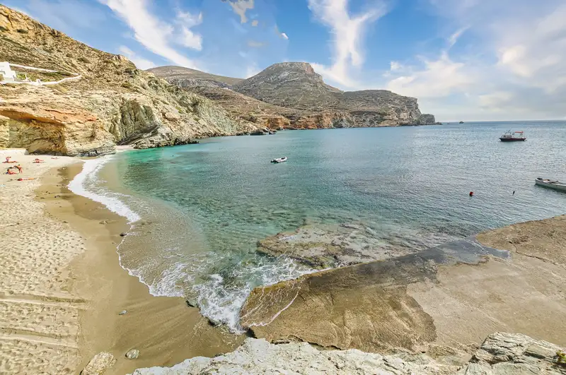 Agali beach folegandros with sandy shore and small boats in the bay
