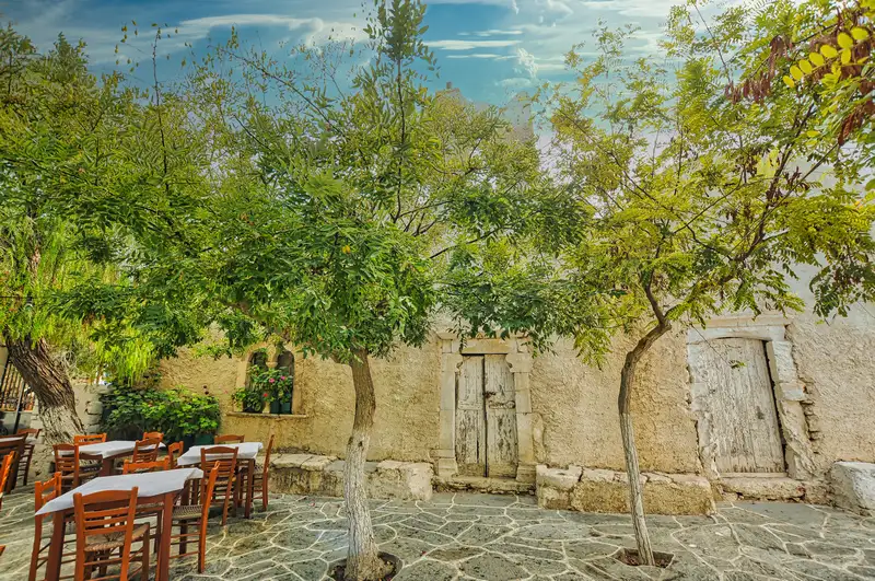 Chora central square in Folegandros with trees and tavernas under their shade