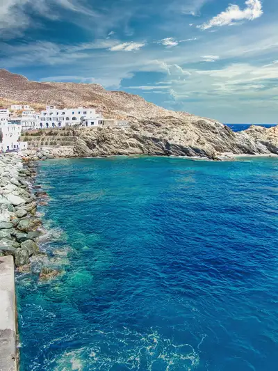 Karavostasis port in Folegandros with deep blue water and whitewashed houses
