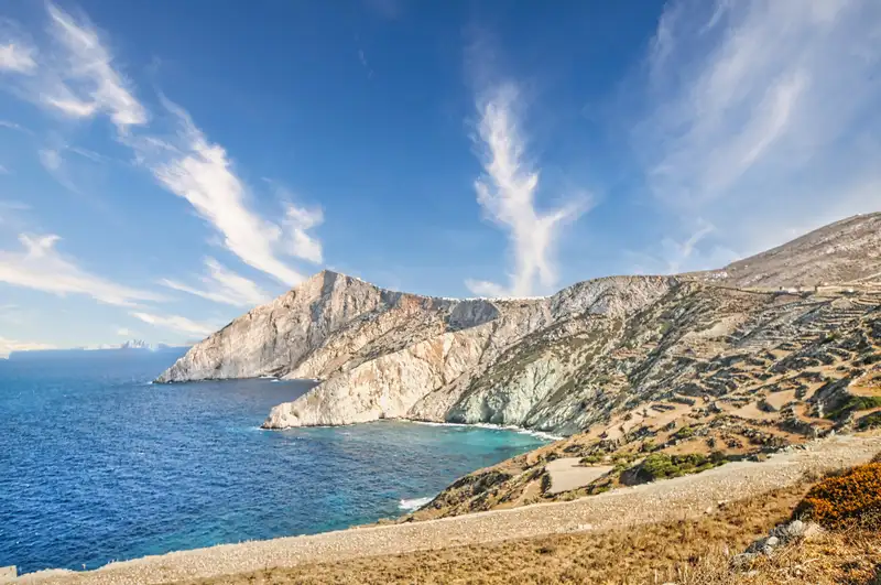 Mountain view of Folegandros with dramatic cliffs falling into the deep blue sea