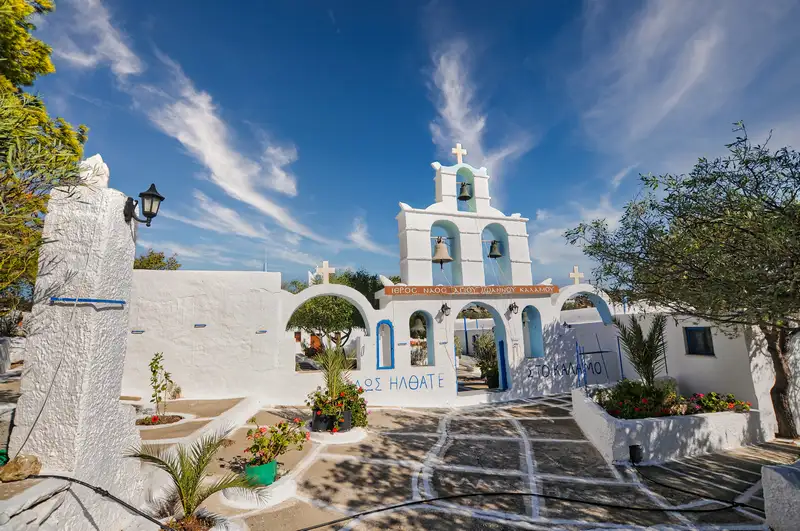The Monastery of Agios Ioannis Kalamos on Ios island, a whitewashed chapel with three bells