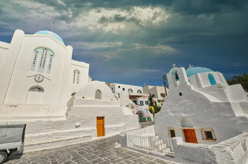Blue-domed chapels in Chora of Ios, set against the whitewashed Cycladic village