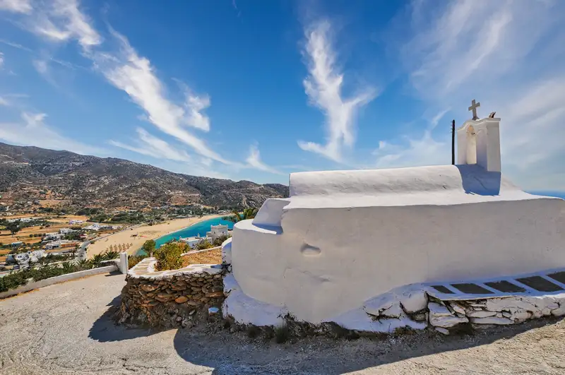 A whitewashed chapel on the hill above Mylopotas beach on Ios island