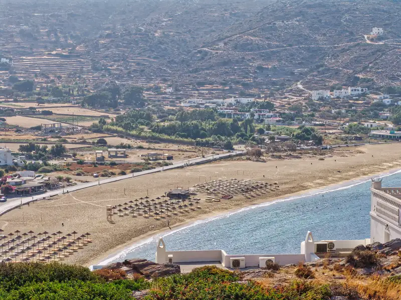 The long stretch of Mylopotas on Ios, with rows of beach umbrellas