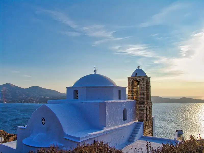 The whitewashed church of Panagia Korfiatissa above Plaka village at sunset on Milos island