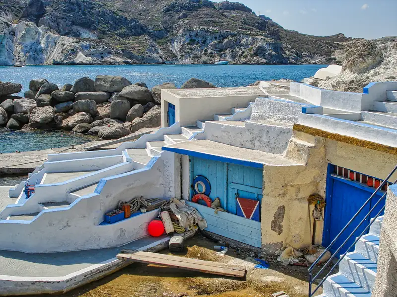 The white fishermen houses of Mandrakia village with blue doors on Milos island