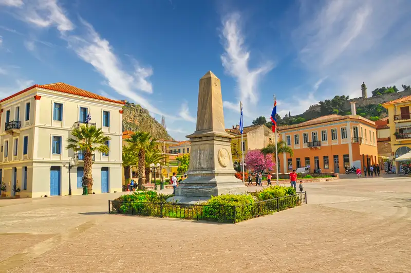 Memorial obelisk and neoclassical buildings in a square of Nafplio