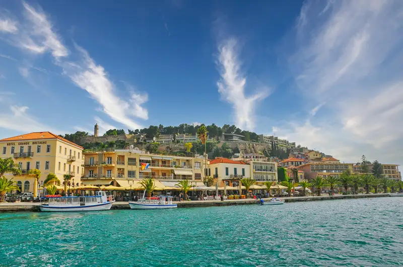 Waterfront and harbour of Nafplio with the old town climbing toward Akronafplia