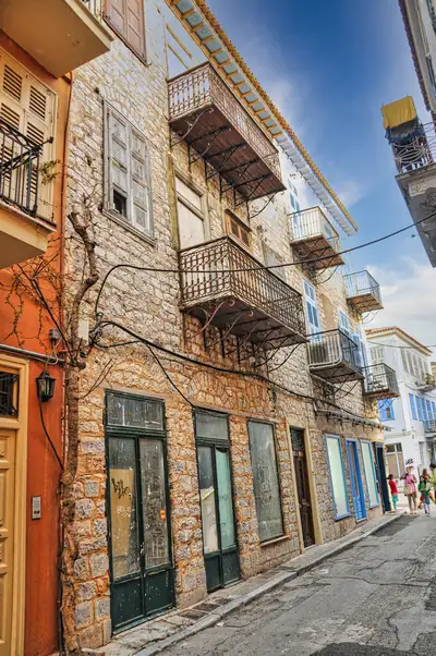 A stone-built lane in the old town of Nafplio with wrought iron balconies