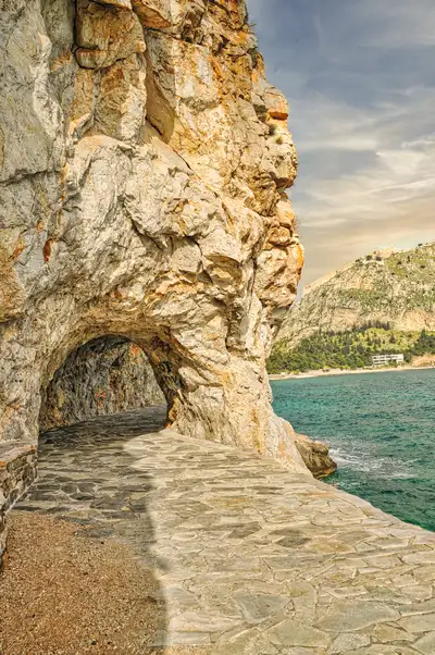 Paved coastal path along the cliffs of Akronafplia toward Karathona beach