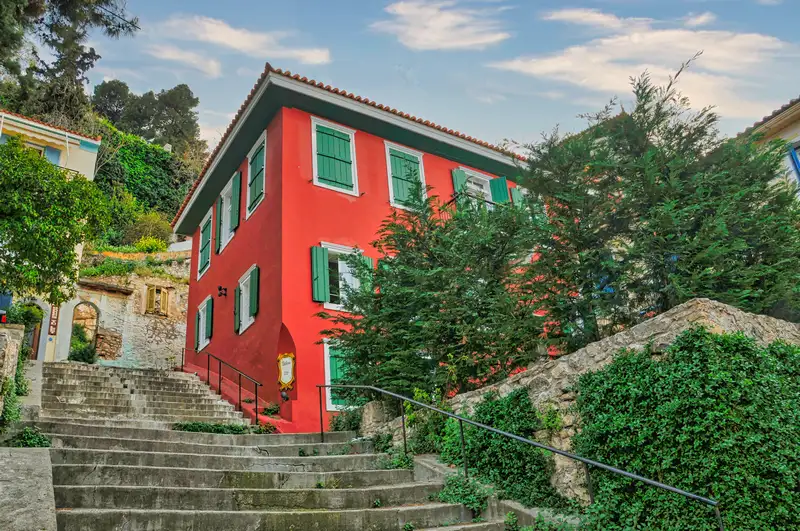 Steps and a striking red mansion in the upper old town of Nafplio