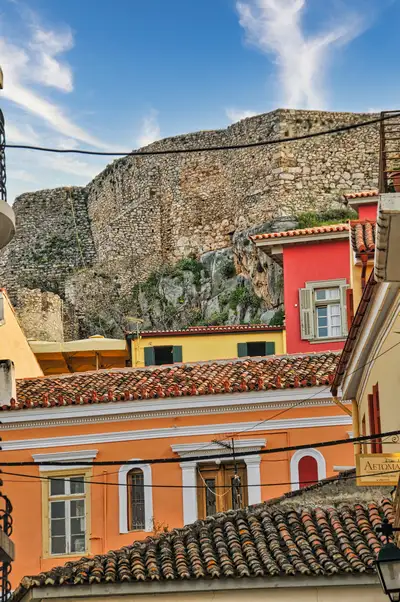 Traditional houses of Nafplio old town with Akronafplia walls rising above