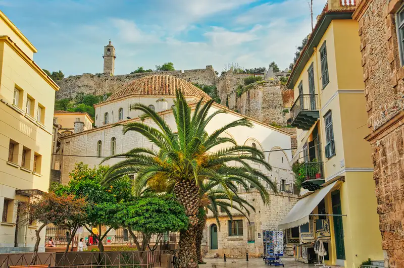 Square in the old town of Nafplio with a palm tree and a former Ottoman building