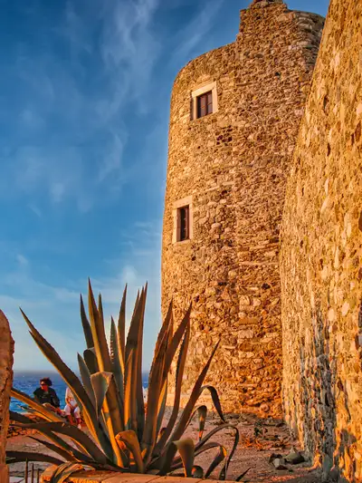 Stone tower of the Venetian Kastro in Naxos with an agave plant