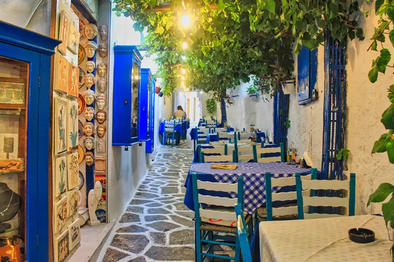 Blue-and-white taverna alley with ceramic masks in Chora Naxos