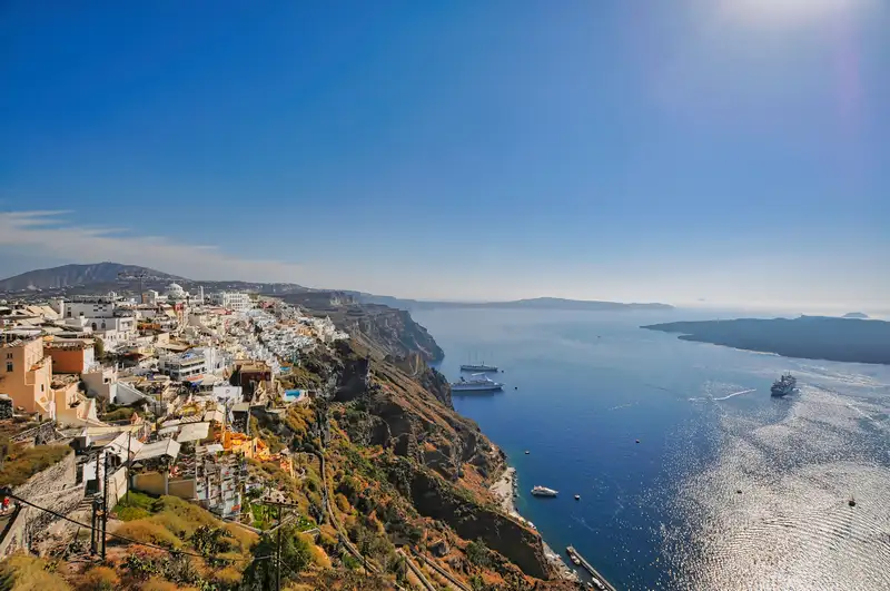 The white town of Fira stretching along the Santorini caldera above the sea