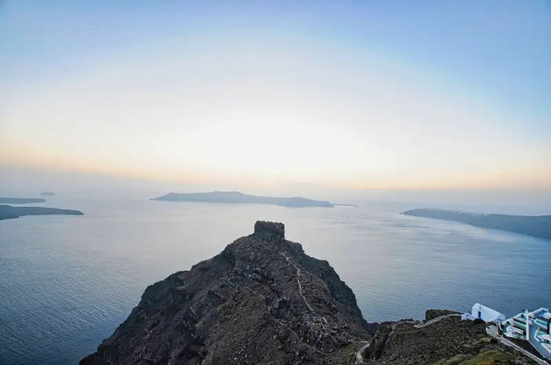 Skaros Rock rising from the Santorini caldera below Imerovigli at dusk