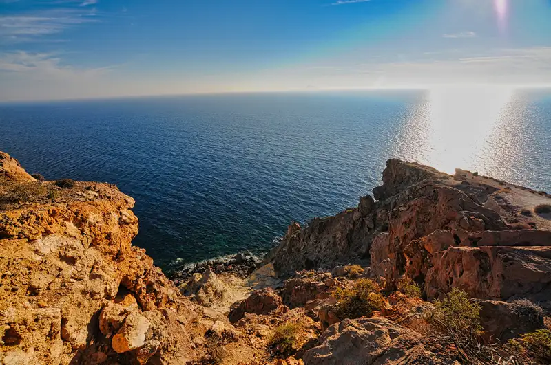 View of the open Aegean from the Akrotiri lighthouse cliffs at the southern tip of Santorini