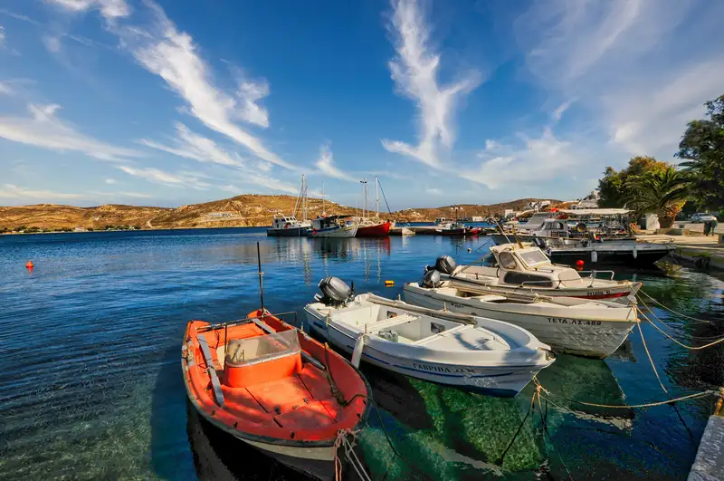 Fishing boats and yachts moored in the harbour of Livadi
