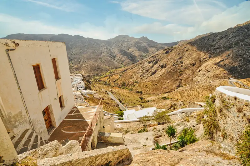 White houses of Chora above a winding road through the dry hills of Serifos