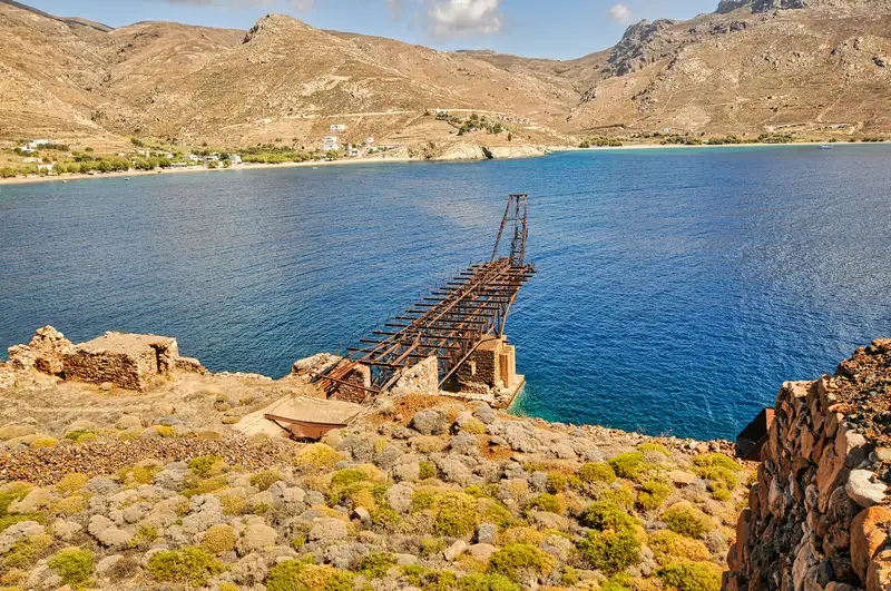 Collapsing wooden mining structure descending toward the bay at Megalo Livadi