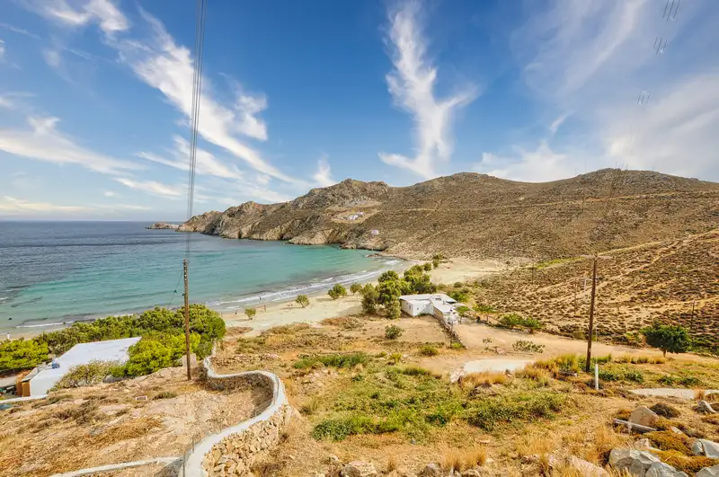 Golden sand and clear shallows at Psili Ammos beach seen from the hill