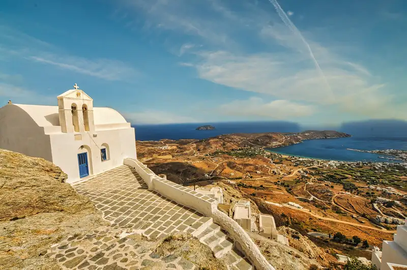 Hilltop chapel with paved steps and a panoramic view of the coast
