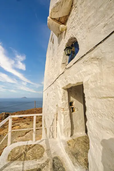 Thick white walls of the Taxiarches Monastery overlooking the Aegean, Serifos