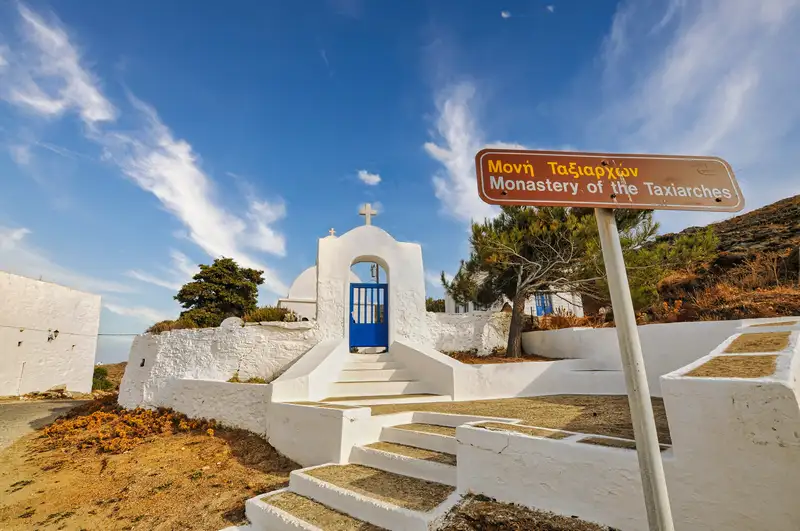 Whitewashed gate and blue door at the entrance to the Monastery of Taxiarches