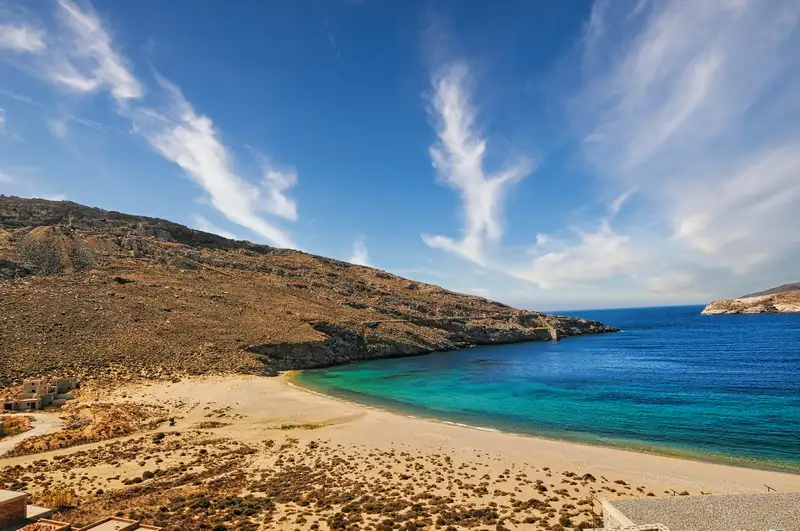 Sandy Vagia beach and turquoise water below a bare hill in Serifos