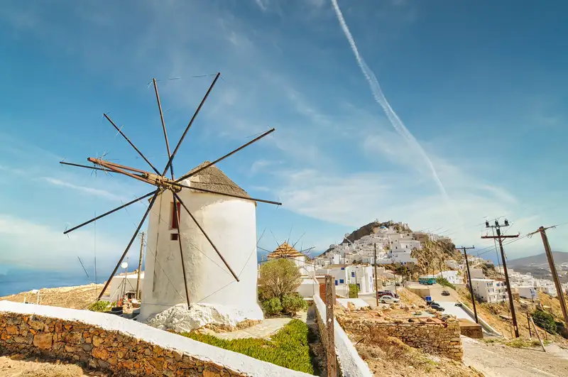 Old windmill with Chora and the Kastro hill rising behind in Serifos