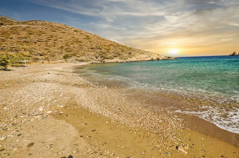Agios Georgios beach in Sikinos with golden sand and clear turquoise water