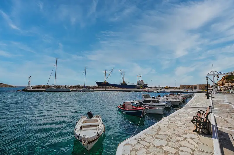Stone quay and moored boats at the port of Alopronia in Sikinos